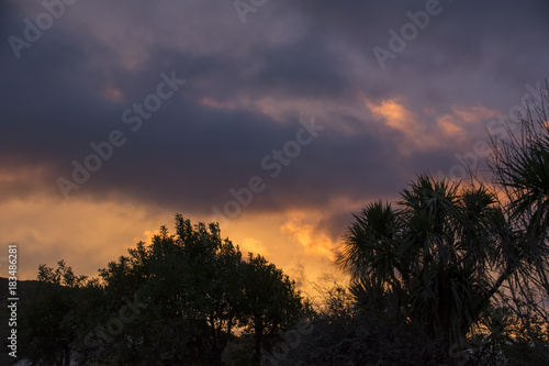 Hillside fire reflected in clouds