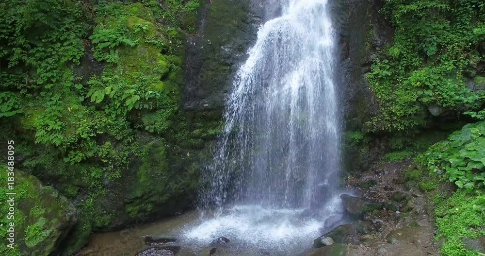 vertical aerial panorama of cascading waterfall in green thicket vertical aerial panorama of cascading waterfall in green thicket