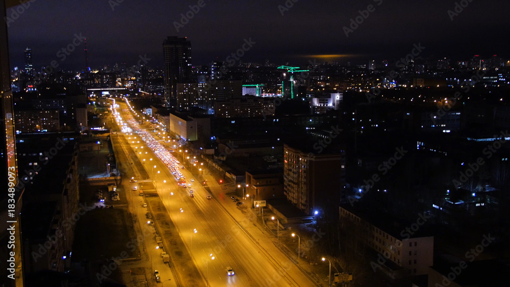 Light trails on the modern building. The life of the city at night with traffic. Concept of night life