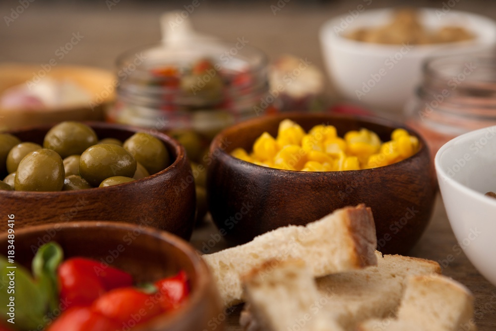 Olives and corns in bowls by ingredients Olives and corns in bowls by ingredients