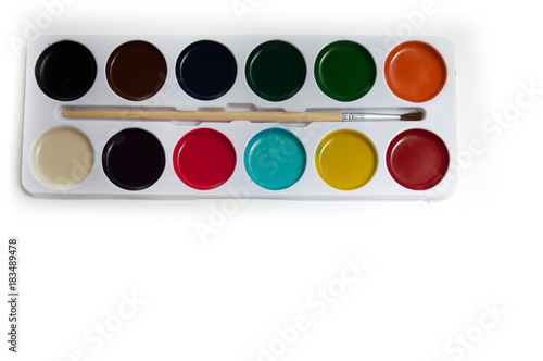 Set of watercolor paints and paintbrush for painting closeup isolated on white background