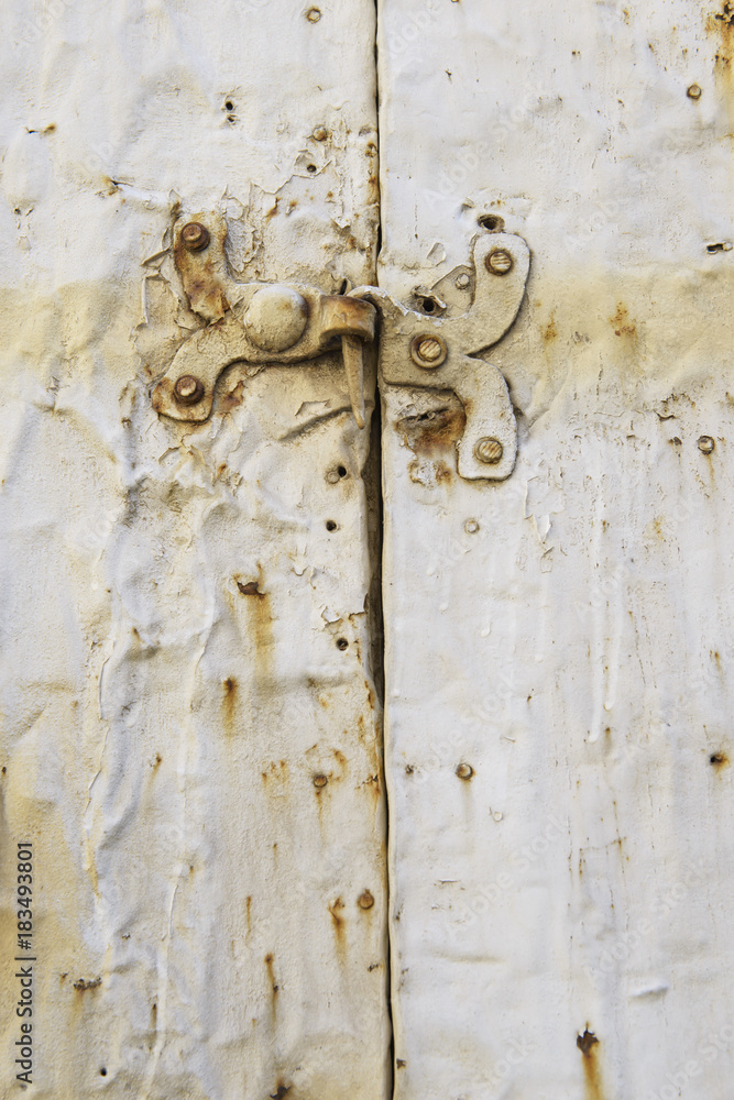 wooden door entrance with metal features.metal rounded hinge on old timber door. stone building with plank door. rusty nails on wood wooden door entrance with metal features.metal rounded hinge on old timber door. stone building with plank door. rusty nails on wood