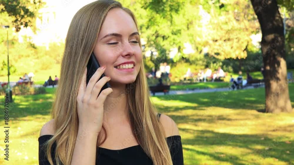 Young beautiful woman phone in the park in sunny day Young beautiful woman phone in the park in sunny day