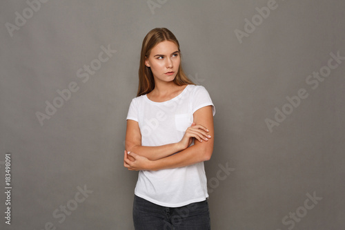 Cheerful girl in casual clothes posing at studio