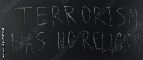 Photography Text of terrorism has no religion on blackboard