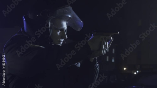 A police officer aiming a gun at the offender photo