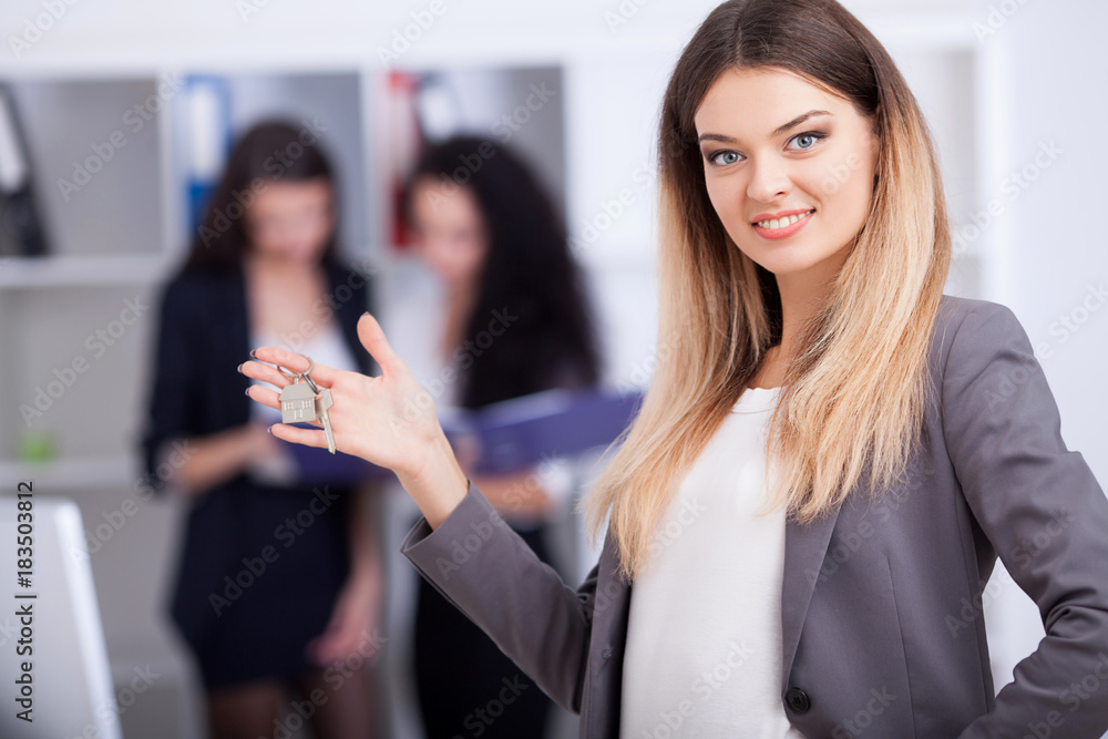 Meeting with agent in office, buying renting apartment or house, buyers of real estate ready to conclude a deal, two women shaking hands with realtor after signing documents for realty purchase . Meeting with agent in office, buying renting apartment or house, buyers of real estate ready to conclude a deal, two women shaking hands with realtor after signing documents for realty purchase .