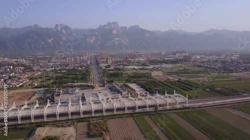 China Huayin Aerial v2 Flying low besides high speed train station with city mountain views 5/17 photo