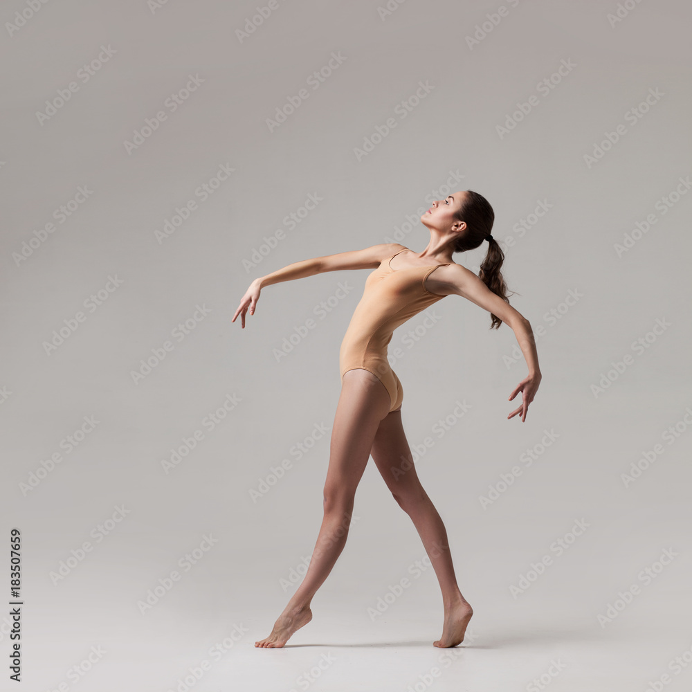 young beautiful dancer in beige swimsuit young beautiful dancer in beige swimsuit
