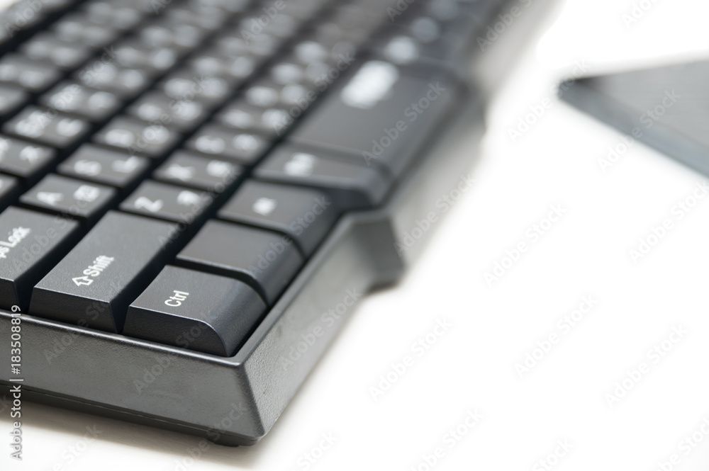 Computer keyboard and phone isolated on white background
