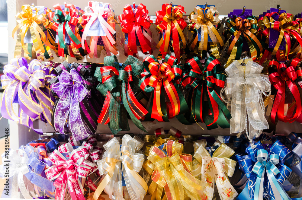 Ribbons and bow are in many colors arranged in a row to wrap the gifts.