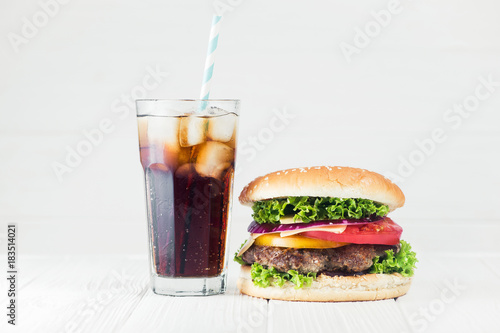 Cold glass of cola and big burger