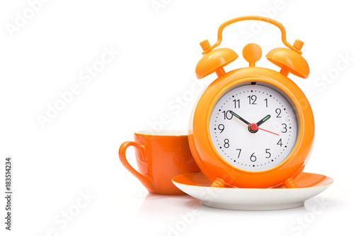 orange coffee cup and alarm clock