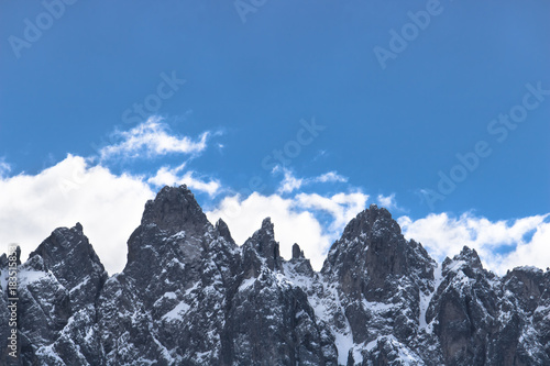 front view of italian dolomites, snowy mountains with copy space on the blue sky