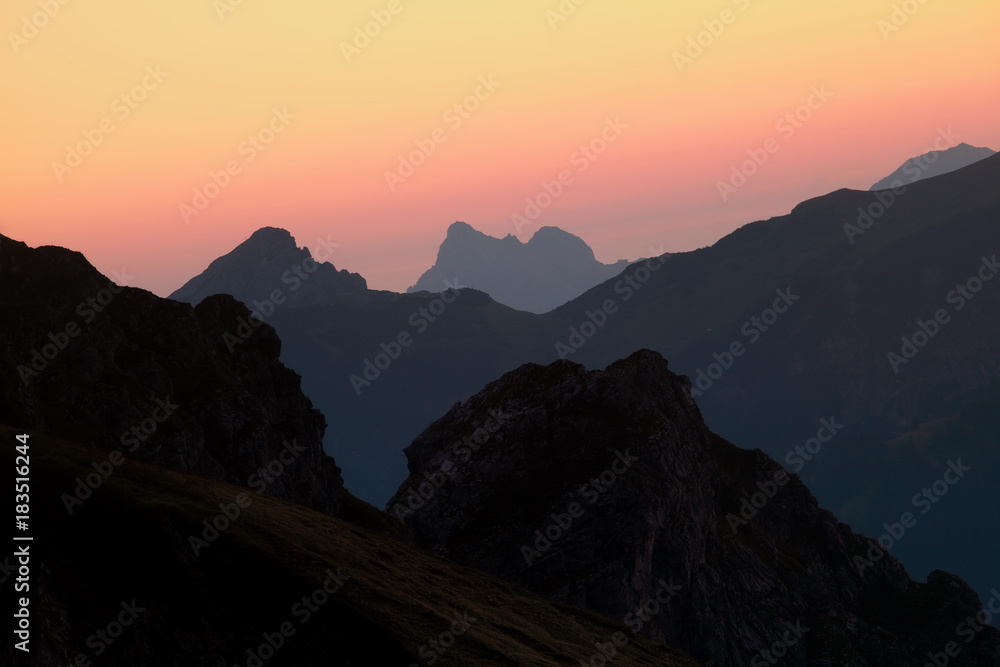 mountain silhouettes over sky at sunrise