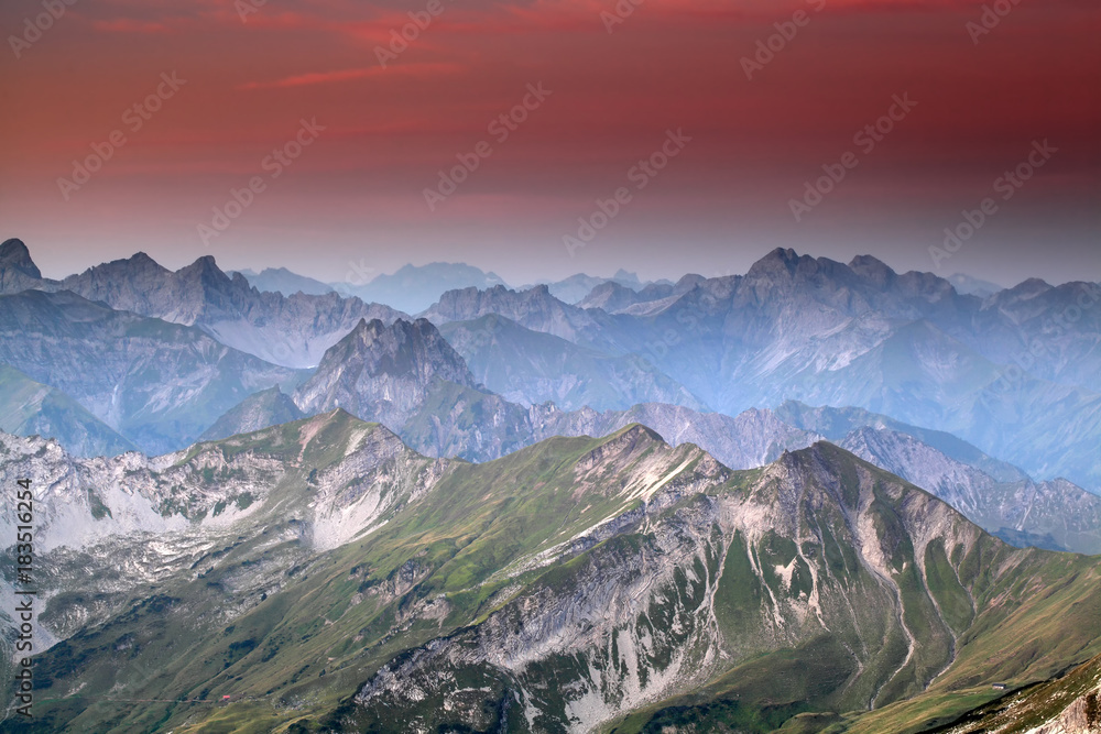 red sunrise over mountain peaks