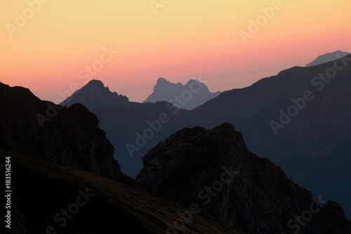 mountain silhouettes over sky at sunrise © Olha Rohulya