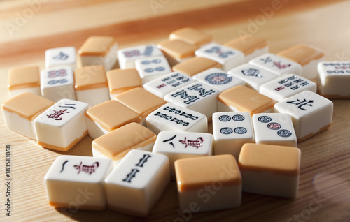 Mahjong tiles on wood table background photo