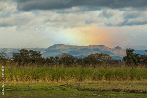 rainbow over the mountains at sunset