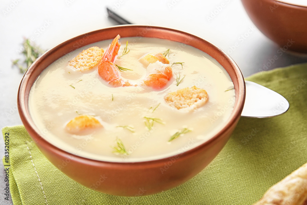 Bowl with yummy shrimp cream soup on table Bowl with yummy shrimp cream soup on table
