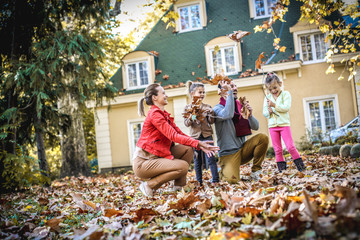 Happy family have fun at front of back yard. On the move.