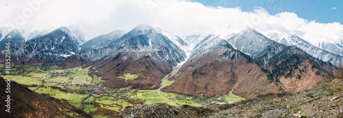 Panoramic view on snow winter spring mountains and cloud sky. Caucasus Mountains. Svaneti region of Georgia. photo