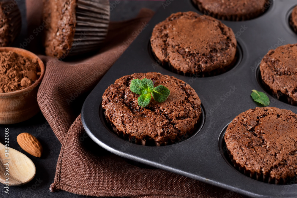 Chocolate muffins, brownies with nuts and chocolate on a black background Chocolate muffins, brownies with nuts and chocolate on a black background