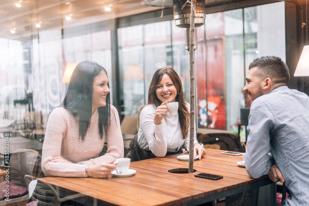 Group of friends having good time in cafe. Group of friends having good time in cafe.