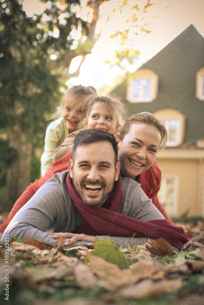 Fototapeta premium Happy family at backyard poses to camera.