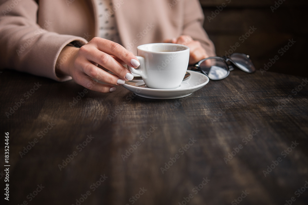 woman with white coffee cup on a table