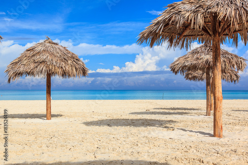 Beach in the Caribbean and umbrellas. © fertatay