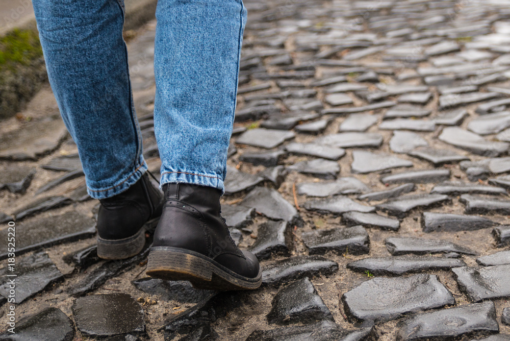 tourist walks on the cobbled pavement urban road tourist walks on the cobbled pavement urban road