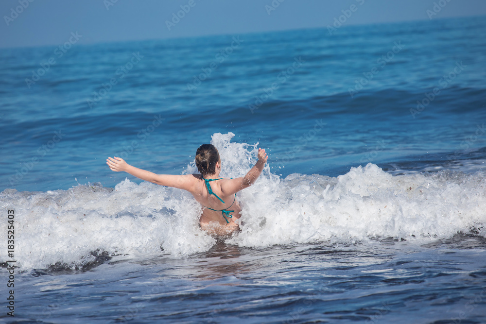 girls splashed by sea wave

