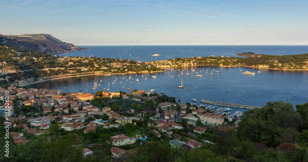 Villefranche-sur-Mer, Saint-Jean-Cap-Ferrat and the Espalmador Bay with yachts and tourist boats in summer (sunset to twilight time-lapse). Cote d'Azur, French Riviera, Alpes Maritimes, PACA, France Villefranche-sur-Mer, Saint-Jean-Cap-Ferrat and the Espalmador Bay with yachts and tourist boats in summer (sunset to twilight time-lapse). Cote d'Azur, French Riviera, Alpes Maritimes, PACA, France