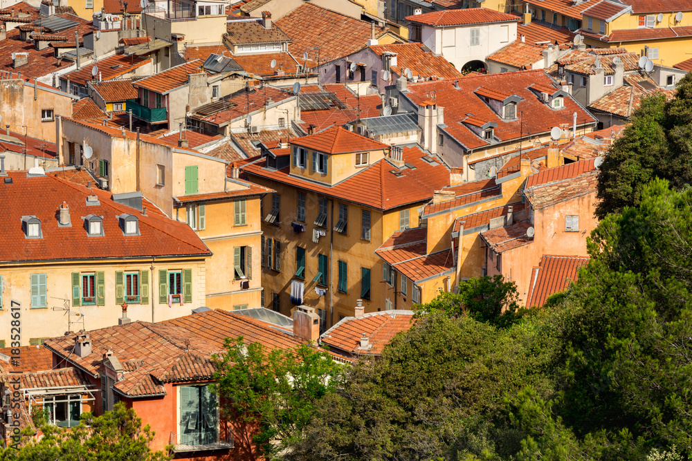 Roofs of Nice in summer with their distinctive terracotta tiles and louvered shutters. French Riviera, Alpes Maritimes, France