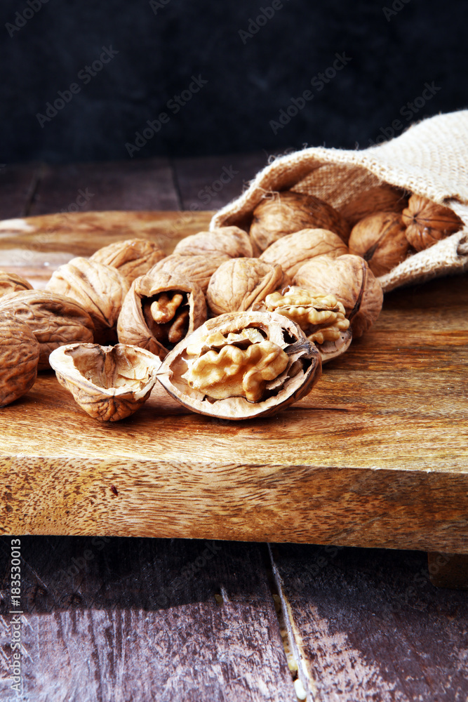 Walnut. Walnut kernels and whole walnuts in burlap sack.