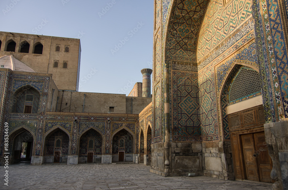 Morning sun in wall of madrasas with traditional mosaic ornament . Samarkand, Uzbekistan