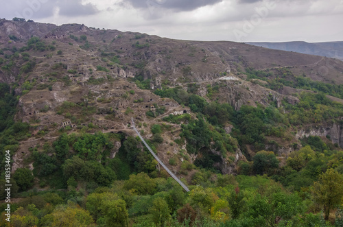 Fototapeta Naklejka Na Ścianę i Meble -  Khndzoresk Swinging Bridge. Suspension bridge over the gorge near Goris village. Armenia