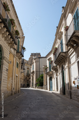 Narrow scenic street in Ragusa, Sicily, Italy with old townhouses