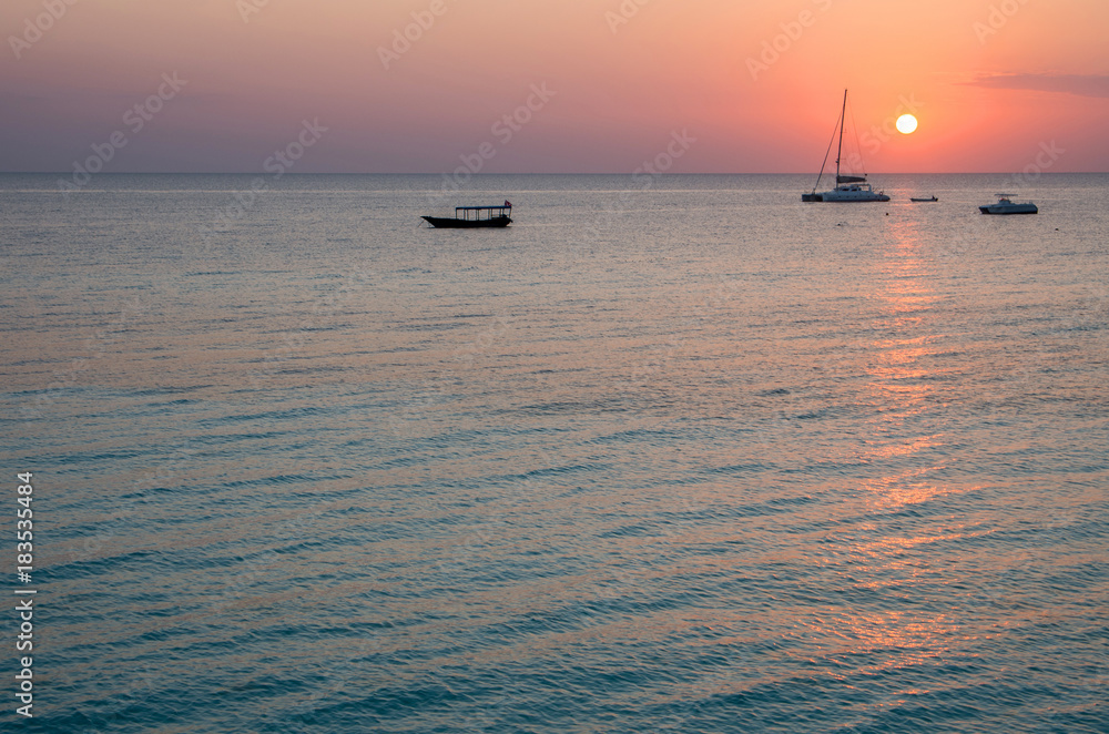 Yacht and boat at sunset.