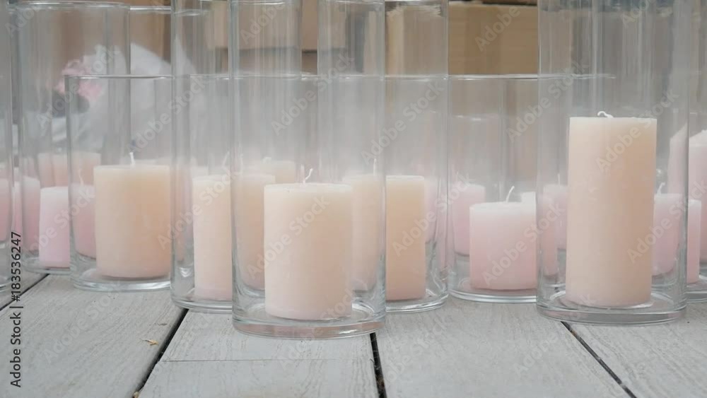 many large pink candles in glass candlesticks many large pink candles in glass candlesticks