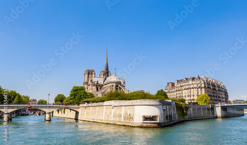 Notre Dame de Paris Catholic Christian Cathedral with the Seine river and  the bridges   Archbishopric and Saint-Louis on a sunny spring day. Paris