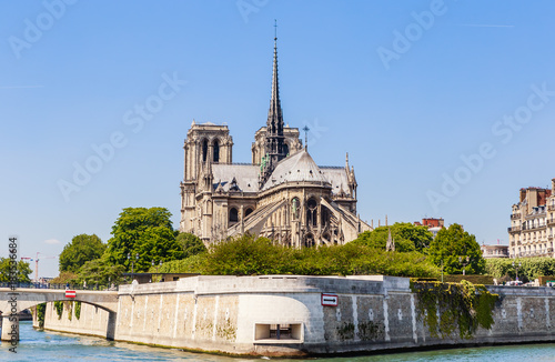 Notre Dame de Paris Catholic Christian Cathedral with the Seine river and the bridge Archbishopric on a sunny spring day. Paris
