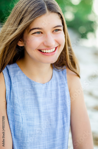 Portrait of a girl in a blue dress with long hair. girl is traveling. beautiful cheerful girl. Portrait of a cheerful girl traveler. I'm enjoying life. Happiness in every day. 