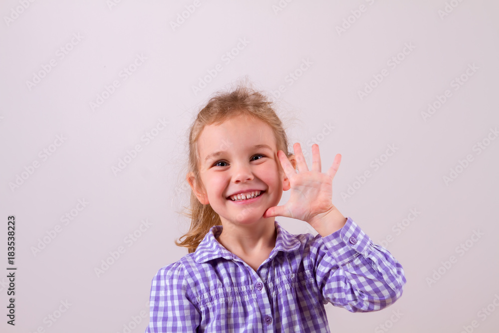 Cute little girl happily shows an open hand Cute little girl happily shows an open hand