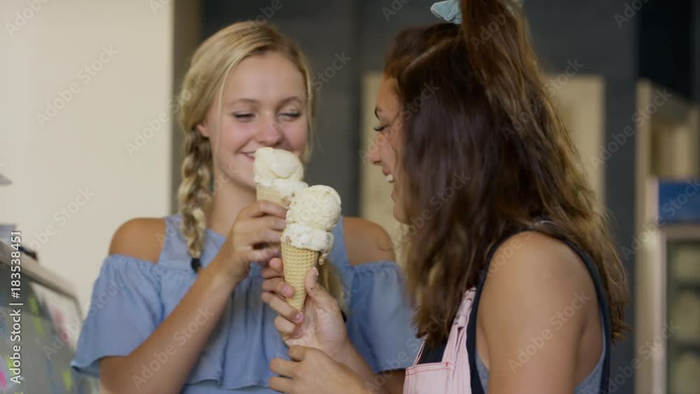 Girls tasting ice cream cones then leaving ice cream parlor / Provo, Utah, United States Girls tasting ice cream cones then leaving ice cream parlor / Provo, Utah, United States