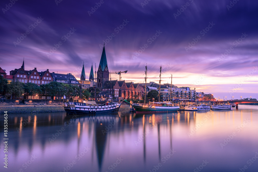 Morning Skyline of  Bremen Old Town as seen over Weser river. Long exposure, artistic filters applied - obrazy, fototapety, plakaty 