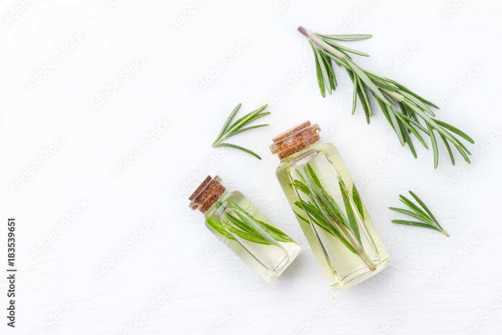 Organic cosmetics with extracts of herbs rosemary on white wooden background. - obrazy, fototapety, plakaty 