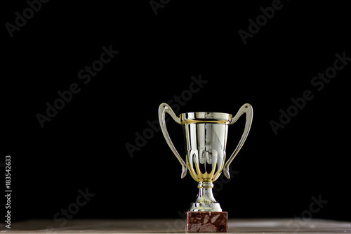 prize, a cup standing on the table. Cup award on a black background.