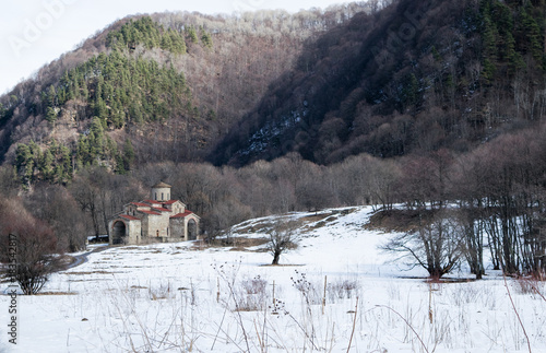 Fototapeta Naklejka Na Ścianę i Meble -  the road to an abandoned monastery in the snowy forest